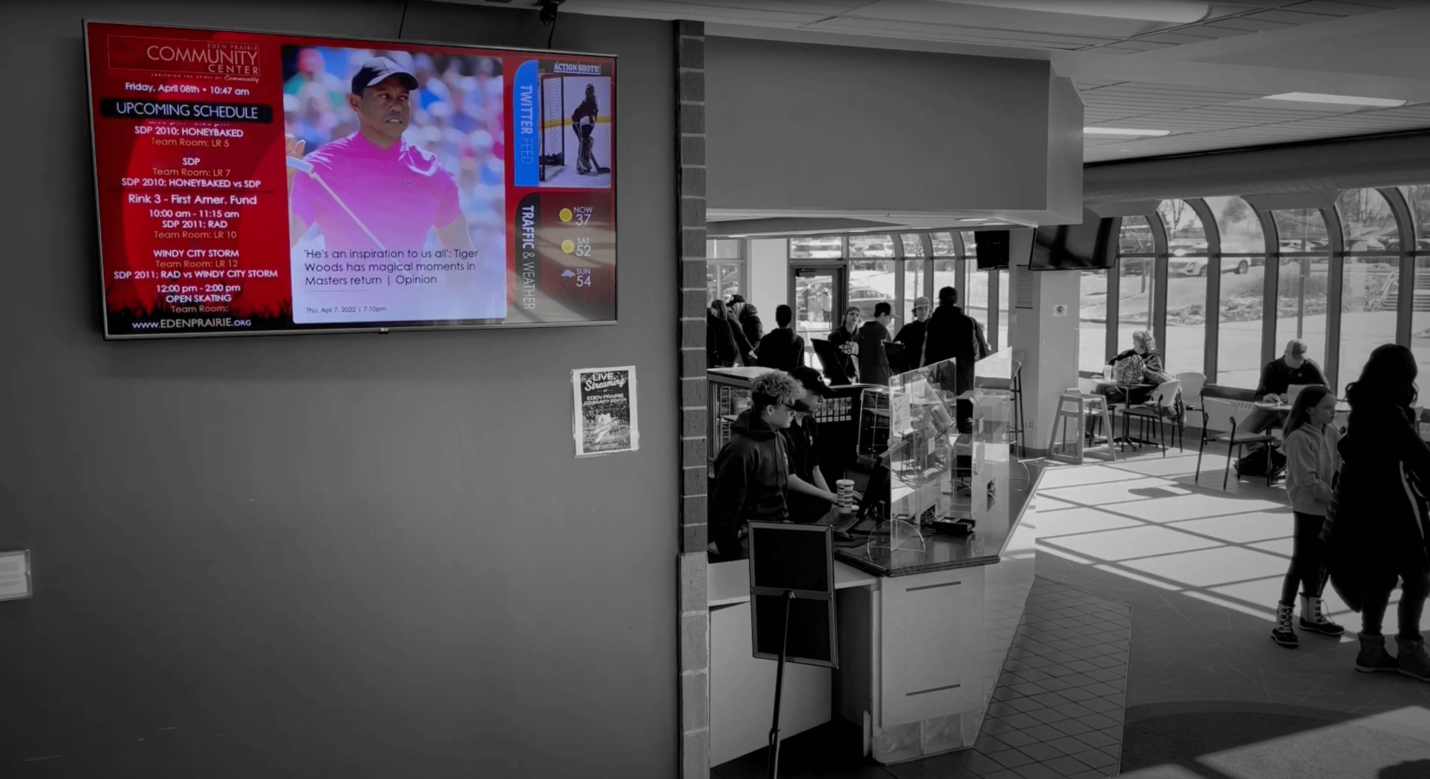 Community Center digital signage screen featured in main lobby hallway, displaying upcoming schedule, socials, and news.