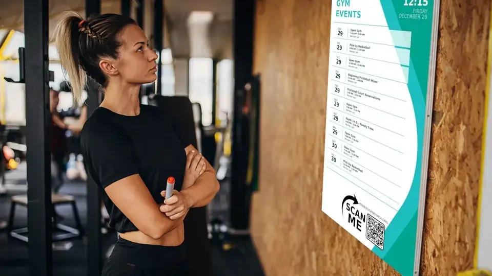 Fitness digital signage from Reach Media Network displaying exercise class schedules.